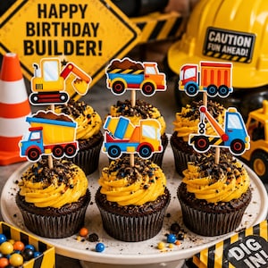 May include: Cupcakes with yellow frosting and chocolate sprinkles, decorated with construction vehicle toppers. The cupcakes are arranged on a white plate, with a sign that says "Happy Birthday Builder!" and a yellow construction hat in the background.