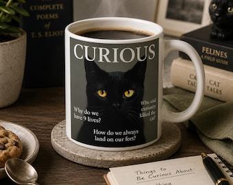 May include: A white ceramic mug filled with coffee, featuring a black cat with yellow eyes and the word "CURIOUS". The mug has text that reads "Why do we have 9 lives?" and "How do we always land on our feet?" on a stone coaster.
