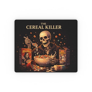 May include: A black mousepad features a skeleton enjoying cereal. The text reads "THE CEREAL KILLER." Boxes of "Killer Os" and "Crypt Charms" cereal are visible. A bowl of colorful cereal and a spilled milk carton complete the design.
