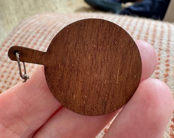 Dollhouse miniature wooden chopping board made of walnut wood.
