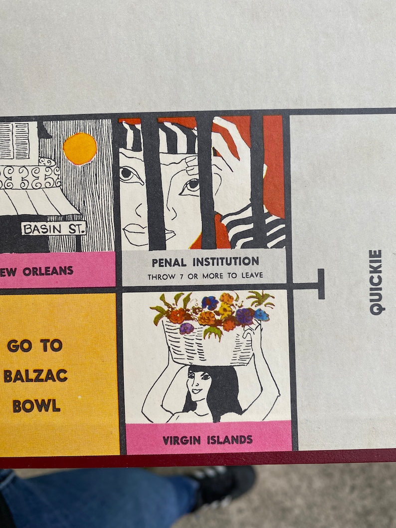 May include: A vintage game board square with a pink background and the text "Virgin Islands". A woman with black hair is holding a basket of flowers above her head. The square is next to a square with a yellow background and the text "Go to Balzac Bowl".