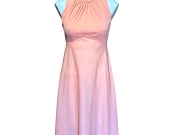 May include: A sleeveless, floor-length peach-colored dress with a high neckline. The bodice features a gathered detail at the neck and a fitted waist. The dress is displayed on a white mannequin against a white background.