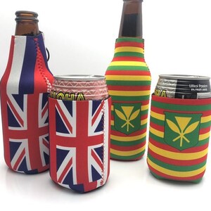 May include: Four beverage insulators in the image. Two feature the Union Jack flag in red, white, and blue. The other two have a green shield with a yellow emblem on a striped background of red, yellow, and green. The insulators are designed to fit bottles and cans.