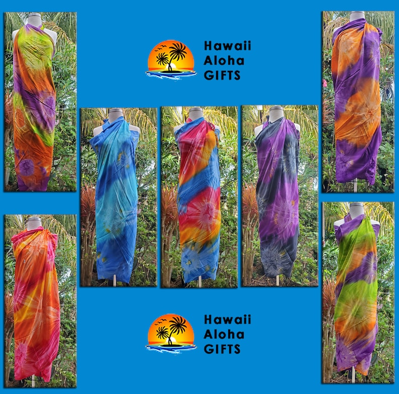 May include: Assortment of colorful tie-dye sarongs in various colors, including blue, orange, purple, and green. The sarongs are displayed on mannequins against a blue background. The text "Hawaii Aloha Gifts" is displayed at the top and bottom of the image.