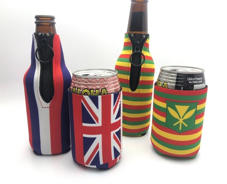 May include: Four beverage insulators in various designs. One features red, white, and blue stripes, another the Union Jack, and two with striped patterns in green, yellow, and red. Each has a black zipper.