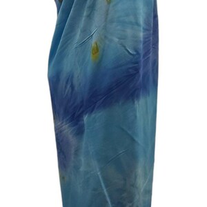 May include: A blue and white tie-dye sarong with a halter neck style. The sarong is made of a soft, lightweight fabric and is perfect for the beach or pool.