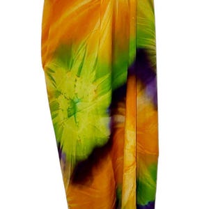 May include: A colorful sarong with a tie-dye pattern in shades of orange, green, purple, and white.
