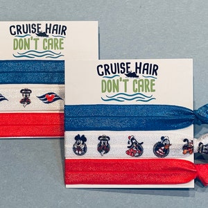 May include: Two sets of hair ties with a red, white, and blue color scheme. The hair ties feature a cruise ship, Mickey Mouse, and the text "Cruise Hair Don't Care".