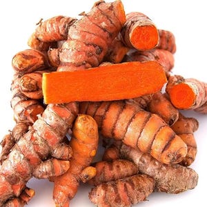 May include: A pile of fresh turmeric roots, showcasing their vibrant orange flesh and textured, brown skin. One piece is sliced, revealing the bright interior. The image is set against a clean white background, highlighting the natural colors and textures.