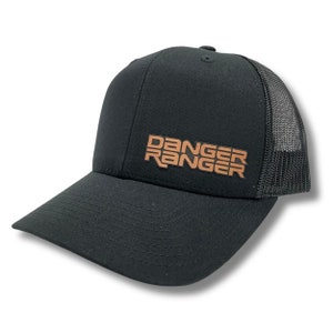 May include: Black trucker hat with a brown embroidered logo that says "DANGER RANGER".