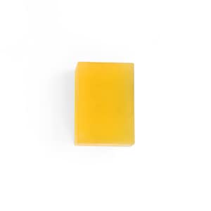 May include: A rectangular bar of yellow soap.