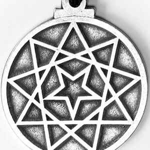 May include: A silver pendant with a geometric design featuring a nine-pointed star. The pendant is round and has a smooth surface.