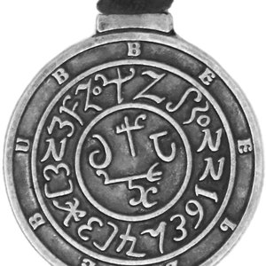 May include: A silver-toned pendant with a circular design featuring a symbol with a cross and a trident. The outer circle has a series of letters and numbers, including "B", "E", "N", and "1391".