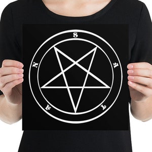 May include: A black and white print featuring a pentagram inside a circle with the letters N, E, S, W, and A around the circle.