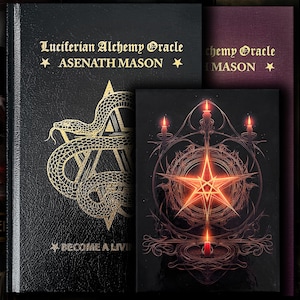 May include: A black hardback book titled Luciferian Alchemy Oracle by Asenath Mason with a gold snake and star graphic, alongside a smaller black book featuring a glowing orange pentagram and candle illustration, with a dark purple book spine visible.