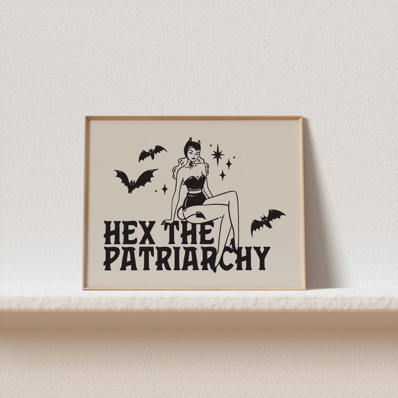May include: A black and white illustration of a woman with horns and a tail sitting on a cloud with bats flying around her. The text "HEX THE PATRIARCHY" is below her.