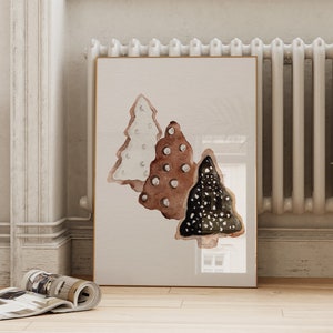 May include: A watercolor painting of three stylized Christmas trees. The trees are painted in shades of brown, white, and black with white polka dots.