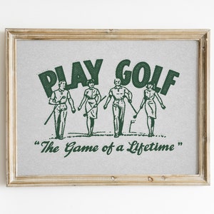 Vintage style horizontal golf print. Green halftone retro golf graphic of two men and two women walking on a golf course with their golf clubs. Text:play golf, the game of a lifetime. Beige background. Great gift for husbands and dads, or kids.