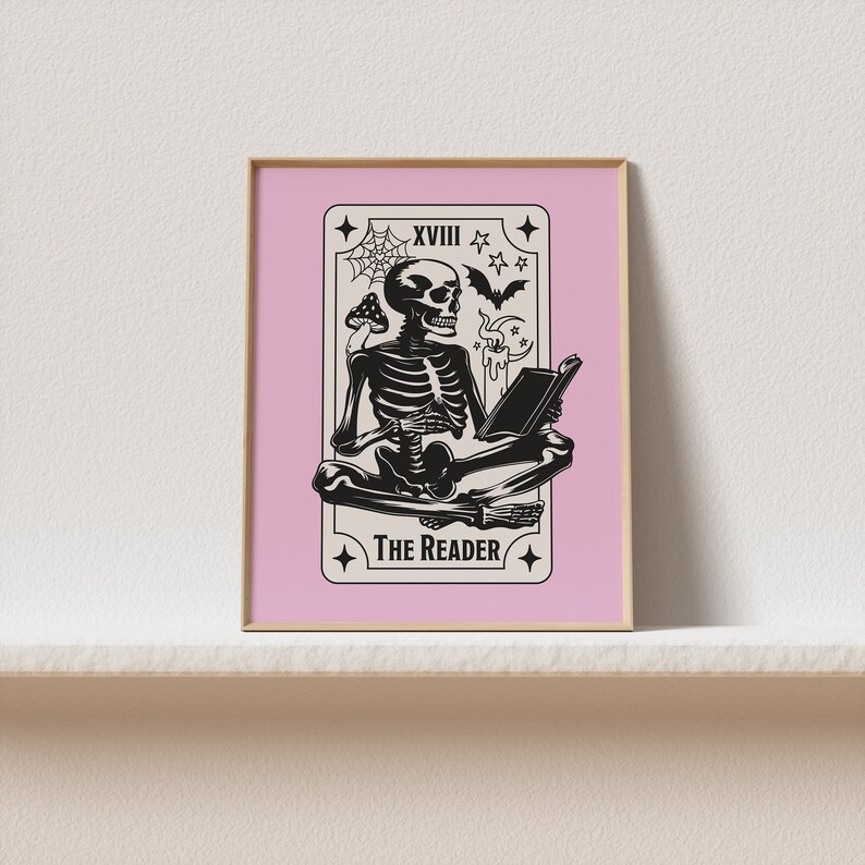 The reader tarot card print. A skeleton reading a book. Pink background, beige and black foreground. Occult witchy reading print. Perfect gift for book lovers.