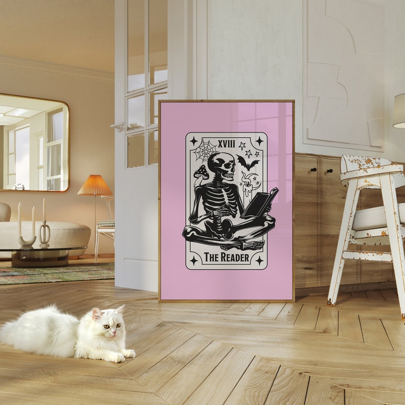 The reader tarot card print. A skeleton reading a book. Pink background, beige and black foreground. Occult witchy reading print. Perfect gift for book lovers.