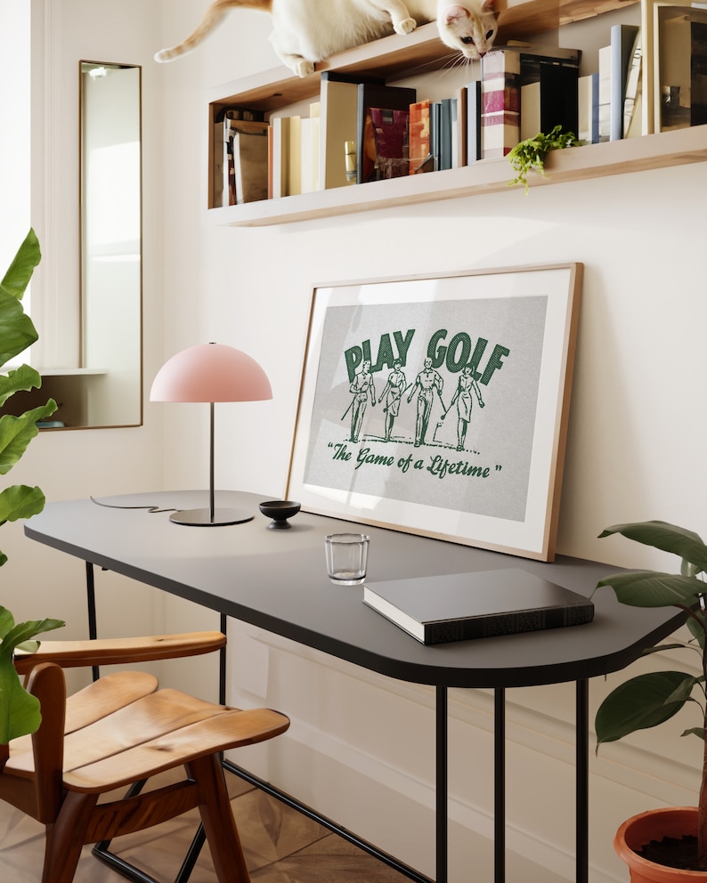 Vintage style horizontal golf print. Green halftone retro golf graphic of two men and two women walking on a golf course with their golf clubs. Text:play golf, the game of a lifetime. Beige background. Great gift for husbands and dads, or kids.