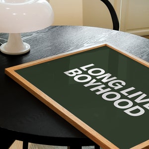 Horizontal long live boyhood print in dark olive green. Green background, white typography in the foreground. Perfect for boys room or nursery.