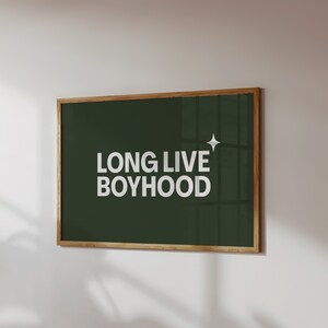 Horizontal long live boyhood print in dark olive green. Green background, white typography in the foreground. Perfect for boys room or nursery.