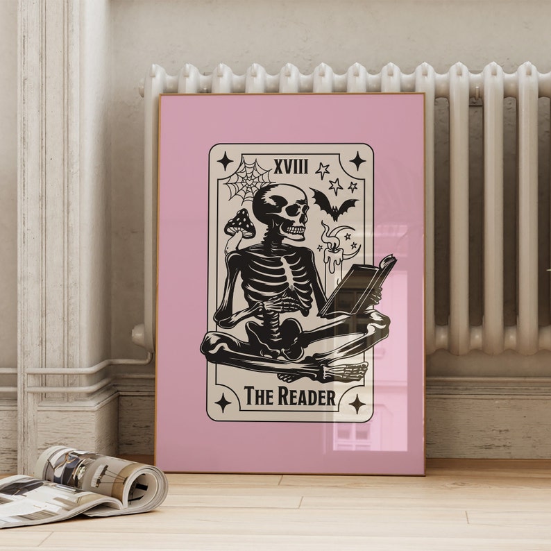 The reader tarot card print. A skeleton reading a book. Pink background, beige and black foreground. Occult witchy reading print. Perfect gift for book lovers.