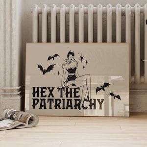 May include: A black and white illustration of a woman with a witch hat and bats flying around her. The text "HEX THE PATRIARCHY" is below the woman.