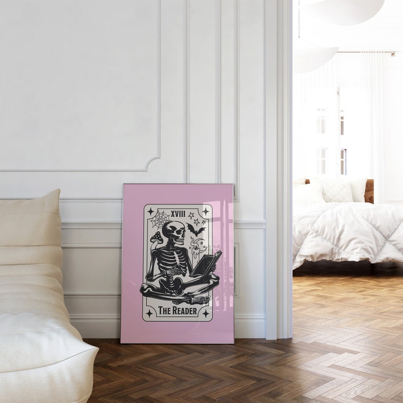 The reader tarot card print. A skeleton reading a book. Pink background, beige and black foreground. Occult witchy reading print. Perfect gift for book lovers.