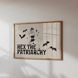 May include: A framed print featuring a black and white illustration of a woman in a witch costume with bats and stars. The text "HEX THE PATRIARCHY" is below the illustration.