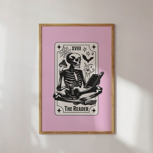 The reader tarot card print. A skeleton reading a book. Pink background, beige and black foreground. Occult witchy reading print. Perfect gift for book lovers.