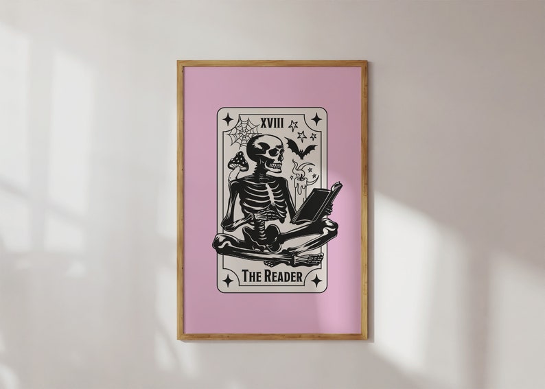 The reader tarot card print. A skeleton reading a book. Pink background, beige and black foreground. Occult witchy reading print. Perfect gift for book lovers.