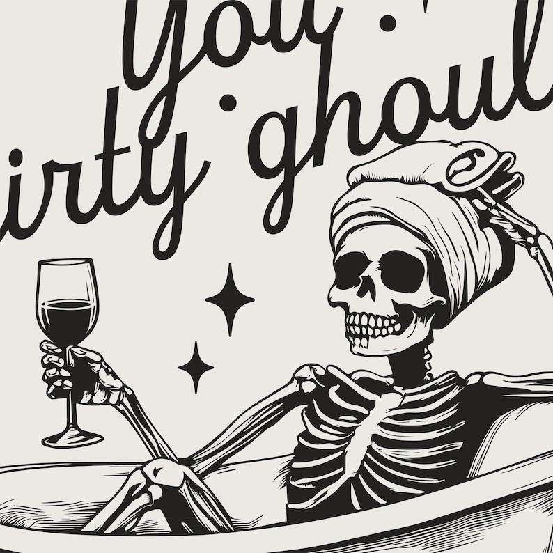 Funny Halloween decor. Light beige background with black foreground. Illustration of a skeleton sitting in a vintage bathtub with a glass of wine and text that reads you dirty ghoul. Perfect bathroom decor for the fall autumn season.