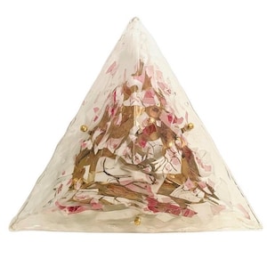 May include: A triangular glass sconce with a floral design. The sconce has a clear, textured glass exterior with pink and gold floral accents. Small gold studs are placed on the corners. The sconce is a decorative lighting fixture.