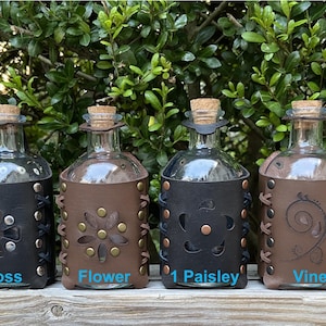 Bottle with belt mounted leather housing
