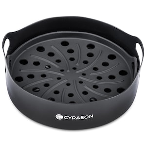 May include: Black air fryer steamer basket with a round, perforated base and two handles. The basket has the word "CYRAEON" printed on the bottom.