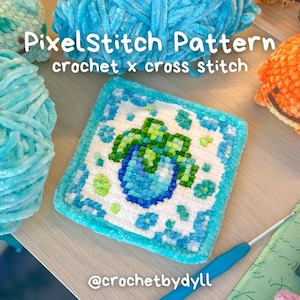 May include: A square crochet piece featuring a pixelated green plant in a blue pot on a white background with a blue border. The text PixelStitch Pattern crochet x cross stitch and @crochetbydyll are visible in the image along with yarn.