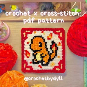 May include: A square, crocheted cross-stitch pattern featuring a Charmander design. The pattern is bordered in red and has a white background with orange and yellow details. The text "crochet x cross-stitch pdf pattern" is at the top, and "@crochetbydll" is at the bottom.