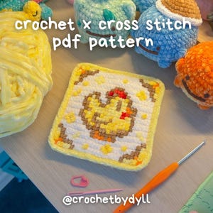 May include: A square, yellow and white cross-stitch pattern featuring a chick design. The text "crochet x cross stitch pdf pattern" is visible. Other crochet items and tools are also in the image.