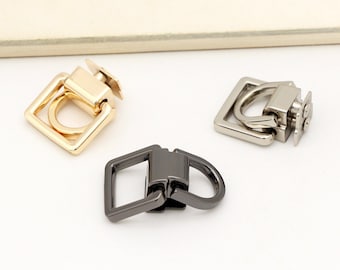 May include: Three metal swivel hooks in gold, silver, and black. Each hook has a square frame with a round ring.