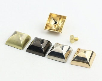 May include: Assortment of pyramid-shaped metal studs in gold, silver, black, and brass finishes. The studs are approximately 1 inch in diameter and come with screws for attaching to fabric or leather.