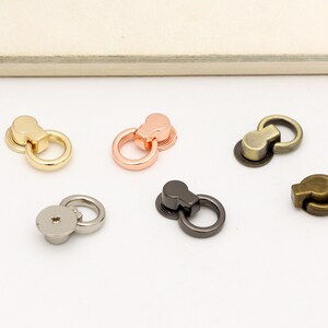 May include: Five different metal ring clasps in gold, rose gold, silver, gunmetal, and antique brass.
