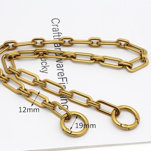 May include: Gold-toned metal chain with two attached clasps. The chain is made of linked rectangular shapes. The chain measures 12 mm wide and 19 mm in diameter. #3