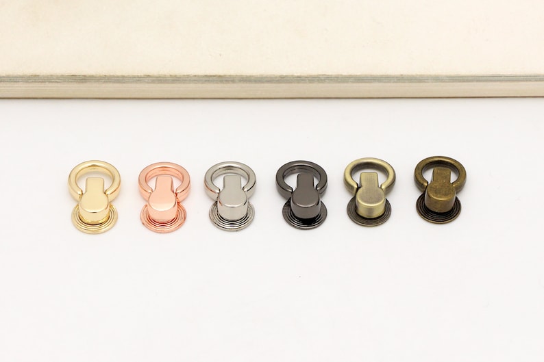 May include: Five metal ring closures in different finishes: gold, rose gold, silver, gunmetal, and antique brass.