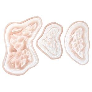 May include: Three irregular, organic-shaped decorative wall art pieces featuring a layered, topographical design. Each piece has a soft, pale peach and white colour palette with raised, textured ridges that mimic natural stone or geological formations.