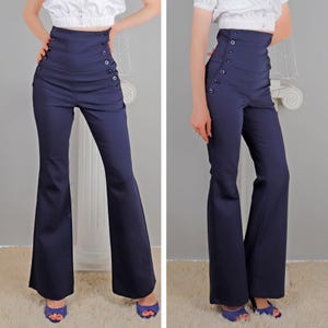 May include: A pair of high-waisted, navy blue, wide-leg pants with a button-up front and a flared leg.