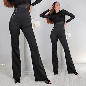 May include: Black high-waisted pants with a flared leg design. The pants feature large, decorative buttons on the front and a fitted silhouette. The model is wearing a black top and black shoes.