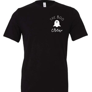 May include: Black t-shirt with the text "THE BOO CREW" and a white ghost graphic. The design is on the upper left chest area. The shirt is a crew neck style.