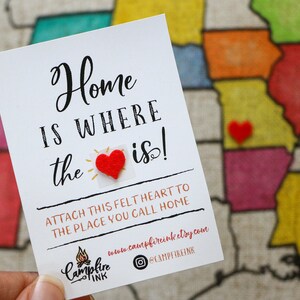 Photo shows a self-adhesive red felt heart that comes with the pillow. You peel the heart off and stick it on the state or town you are from. In the background is an example of what the pillow looks like with the states colored in.